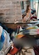 A woman laying on top of a bed covered in blankets.